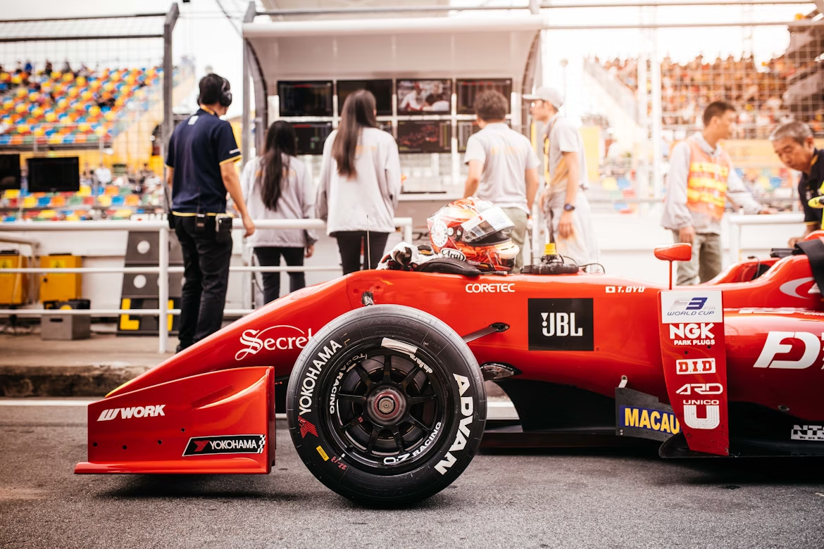 Race car covered in sponsor logos at a motorsport event, illustrating how strategic sponsorship placements build visibility and brand value in sports marketing.